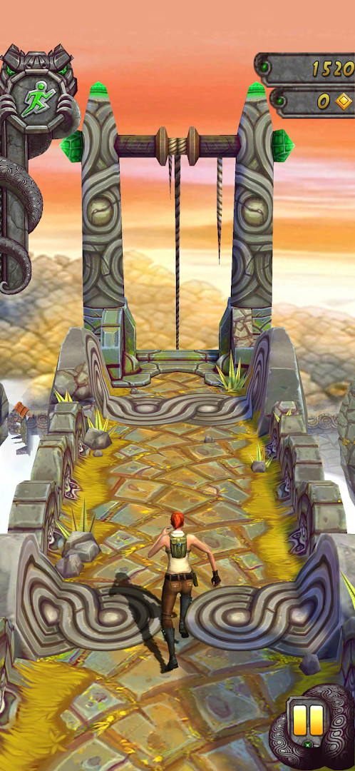 Sliding under a low-hanging obstacle while collecting gold coins on a cliffside path